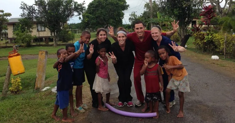 Dr. Grey and his staff with some children